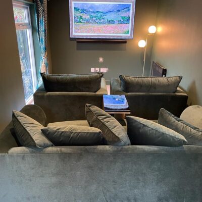 Modern home cinema installation with projector and surround sound speakers.